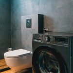 Luxury bathroom with walk-in shower and washing machine for guest use. Charys Premium Home.