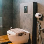 Luxury bathroom with walk-in shower and washing machine for guest use. Charys Premium Home.