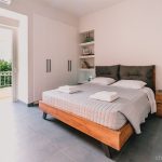 Luxury master bedroom featuring a wide queen-size bed with premium linens and a peaceful ambiance. Charys Premium Home