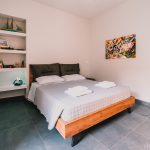 Luxury master bedroom featuring a wide queen-size bed with premium linens and a peaceful ambiance. Charys Premium Home