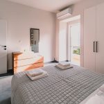Luxury master bedroom featuring a wide queen-size bed with premium linens and a peaceful ambiance. Charys Premium Home