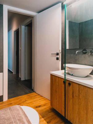 Luxury bathroom with walk-in shower and washing machine for guest use. Charys Premium Home.