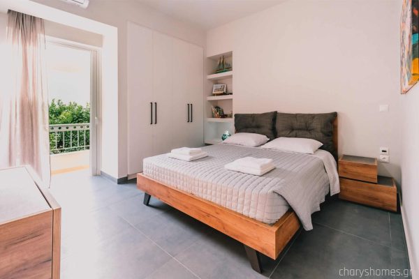 Luxury master bedroom featuring a wide queen-size bed with premium linens and a peaceful ambiance. Charys Premium Home